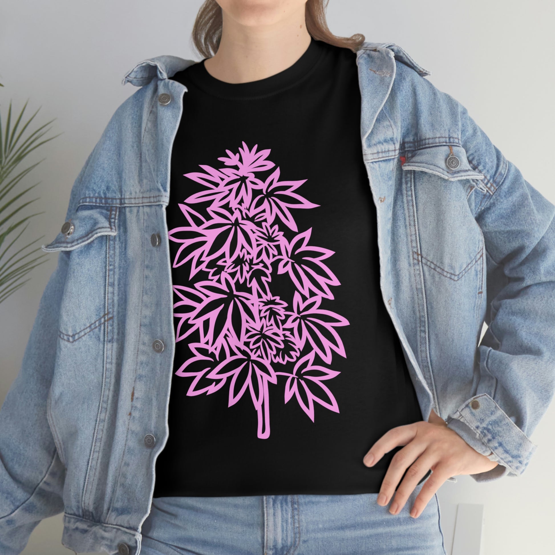 a woman wearing a Pink Cannabis Flowers Tee with pink leaves on it.