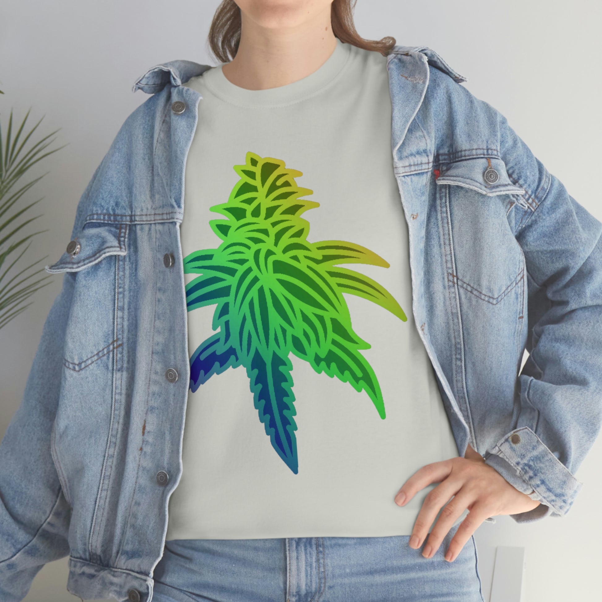 a woman in a jacket is wearing a Rainbow Sherbet Cannabis Tee with a colorful marijuana leaf on it.