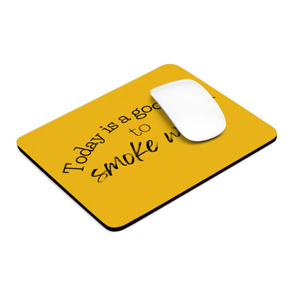 A white computer mouse rests on a Today is a Good Day to Smoke Weed Yellow Mouse Pad with the text "today is a good day to smile widely" written in black script.