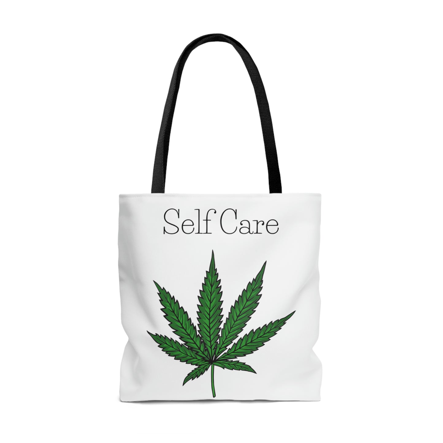A white tote bag with a marijuana leaf on the front with the words "self care" above it