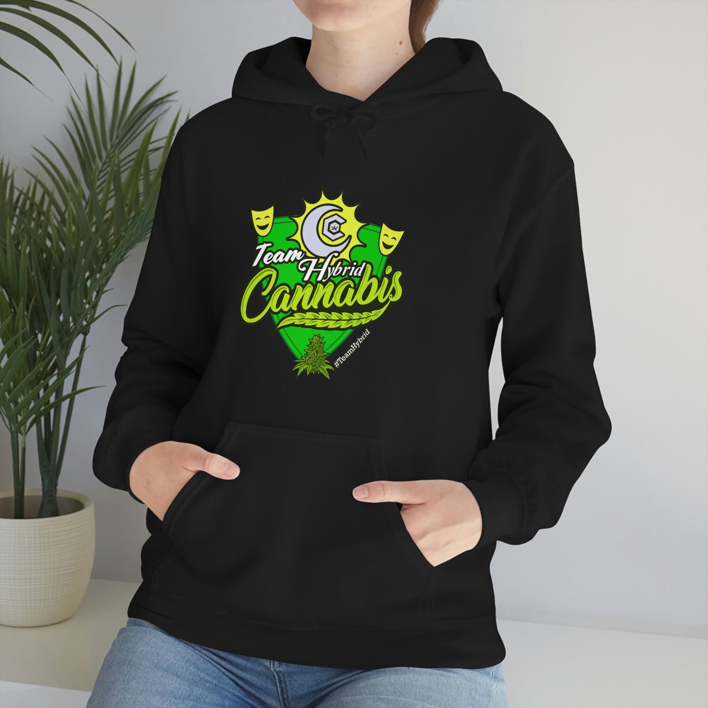 a woman wearing a black Team Hybrid Cannabis Pullover Hoodie with the word cannabis on it.