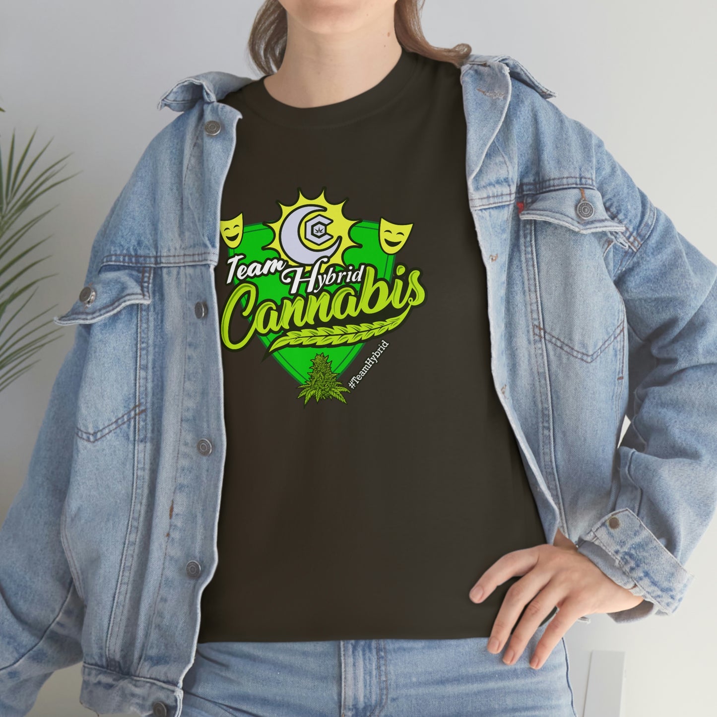 a woman wearing a Team Hybrid Cannabis T-Shirt with a green flower on it.