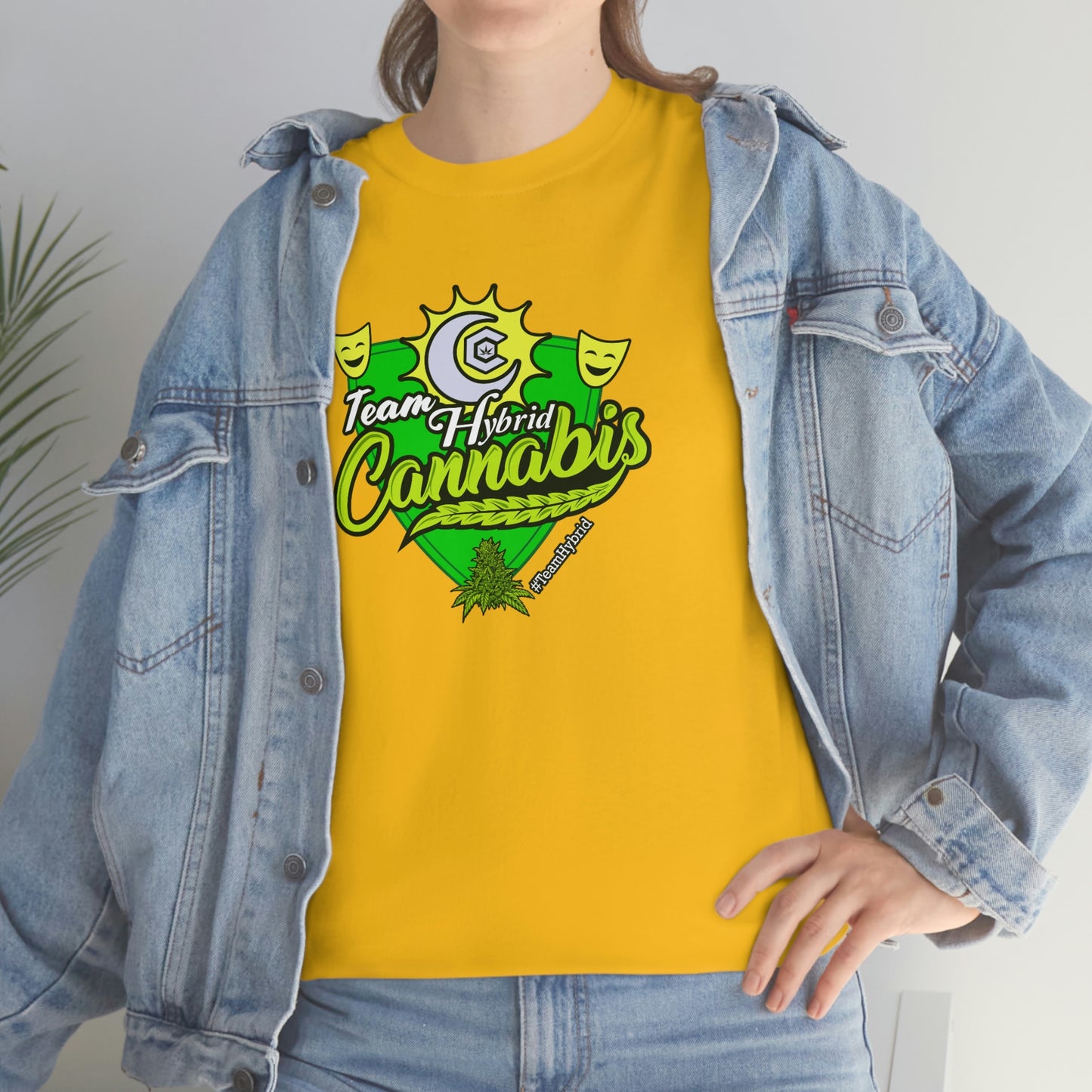 a woman wearing a yellow Team Hybrid Cannabis T-Shirt and jeans.