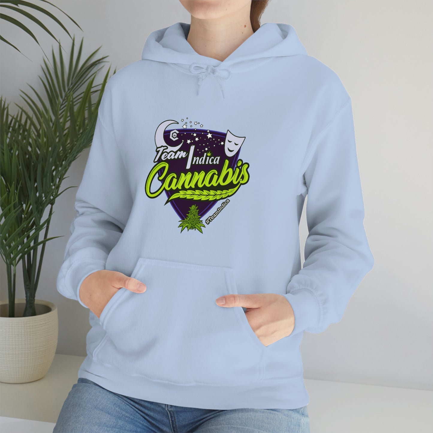 a woman wearing a light blue Team Indica Cannabis Pullover hoodie.