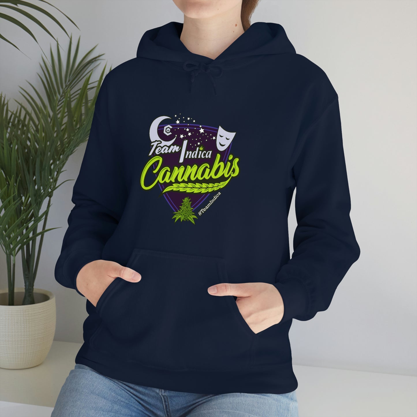 A woman wearing a Team Indica Cannabis Pullover hoodie that says, i love cannabis.