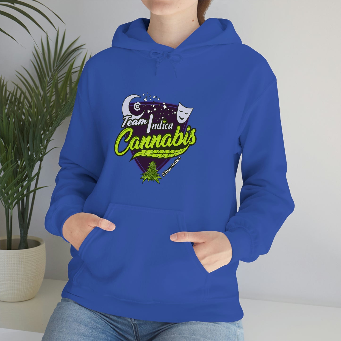 A woman wearing a blue Team Indica Cannabis Pullover hoodie.