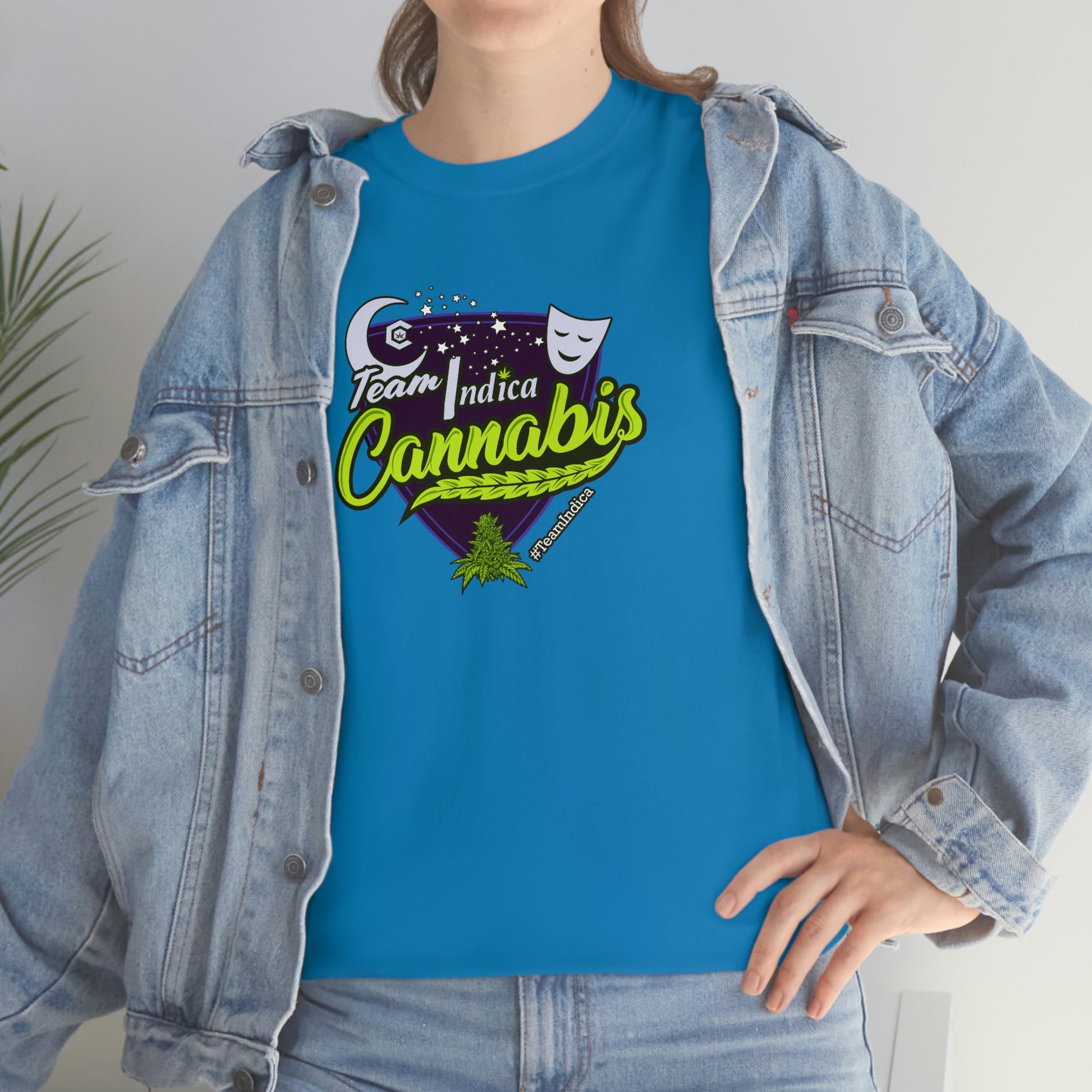 a woman wearing a blue t - shirt with the word 'Team Indica Cannabis T-Shirt' on it.