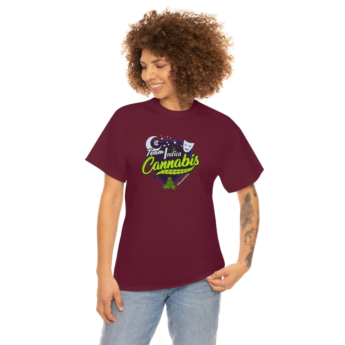 A woman wearing a Team Indica Cannabis T-Shirt in maroon with the word cannabis on it.