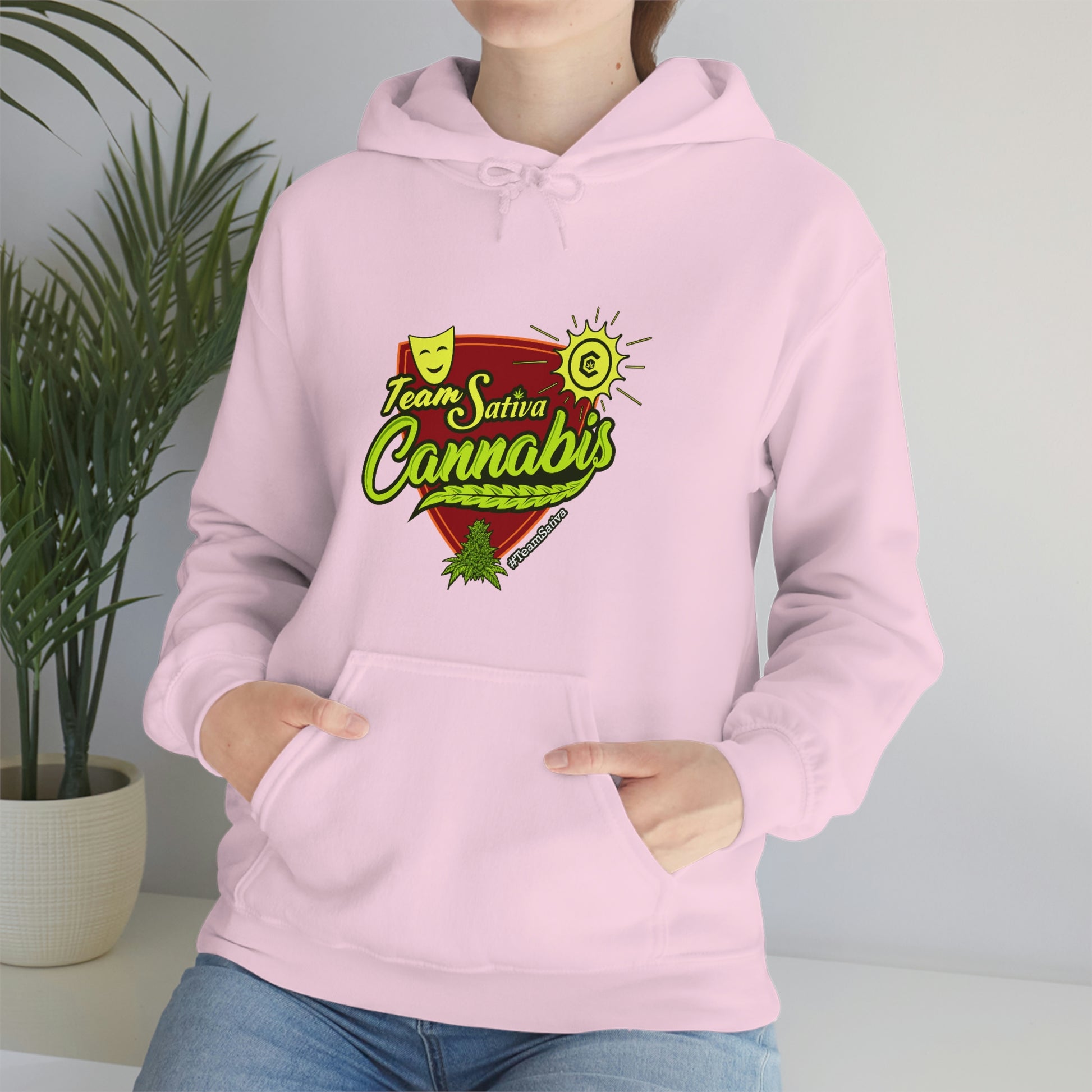 a woman wearing a pink hoodie with the words "Team Sativa Stoner Sweatshirt" on it.