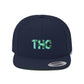 Cool close up of a navy blue THC Snapback Hat with green marijuana leaves on a lighter green background