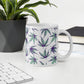 Minty Flower Cannabis Mug on a white desk with a black flower pot next to it