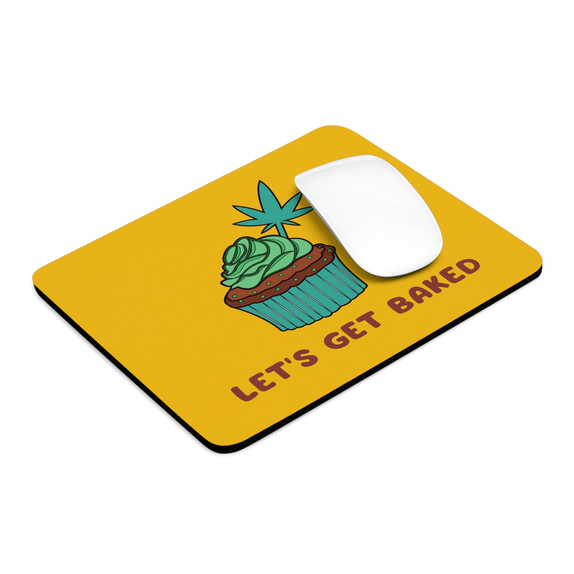 A yellow Let's Get Baked Mouse Pad with a cupcake design on front with a weed leaf protruding out of the top. 