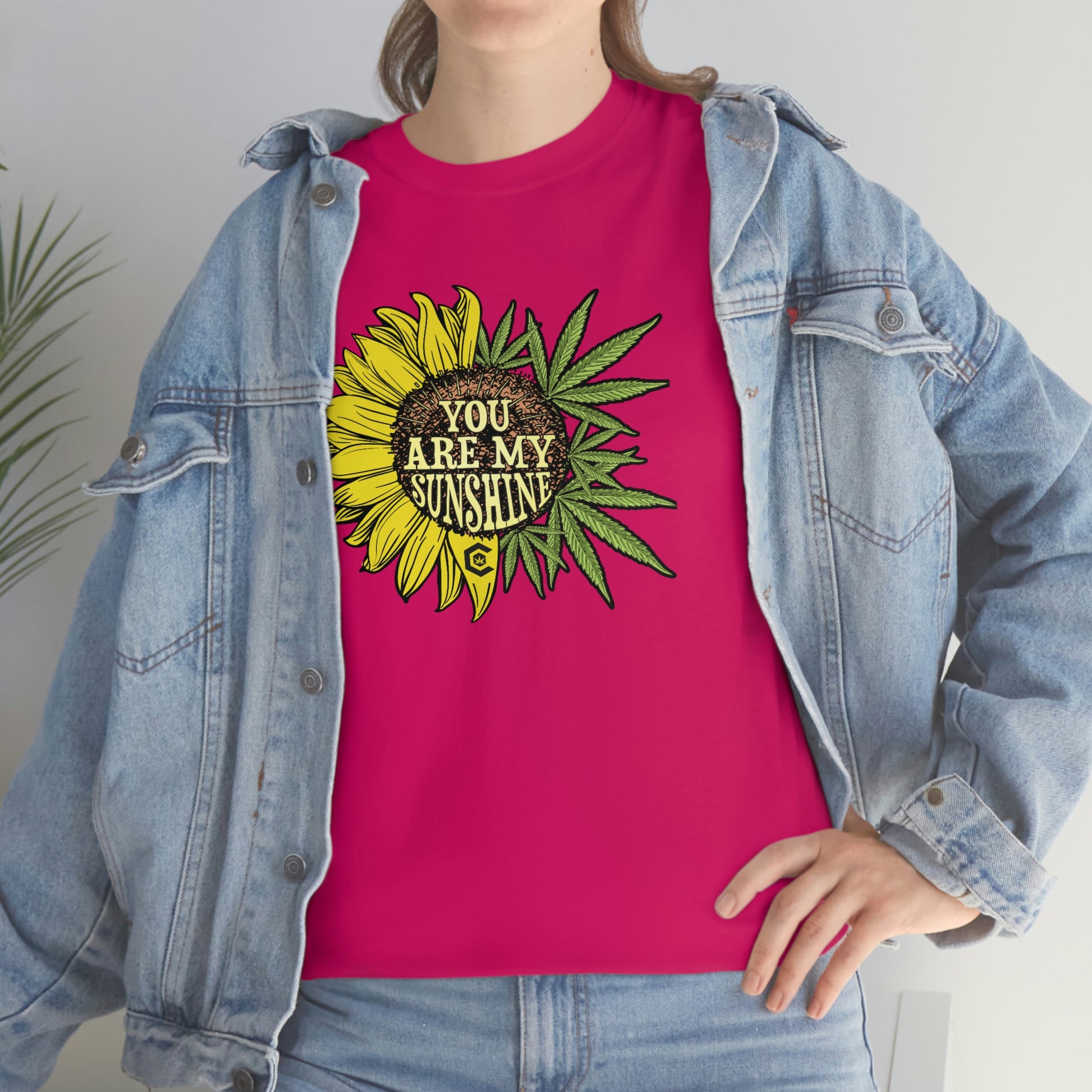 a woman wearing a pink You Are My Sunshine Weed T-Shirt.