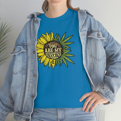 a woman wearing a You Are My Sunshine Weed T-Shirt with a sunflower on it.