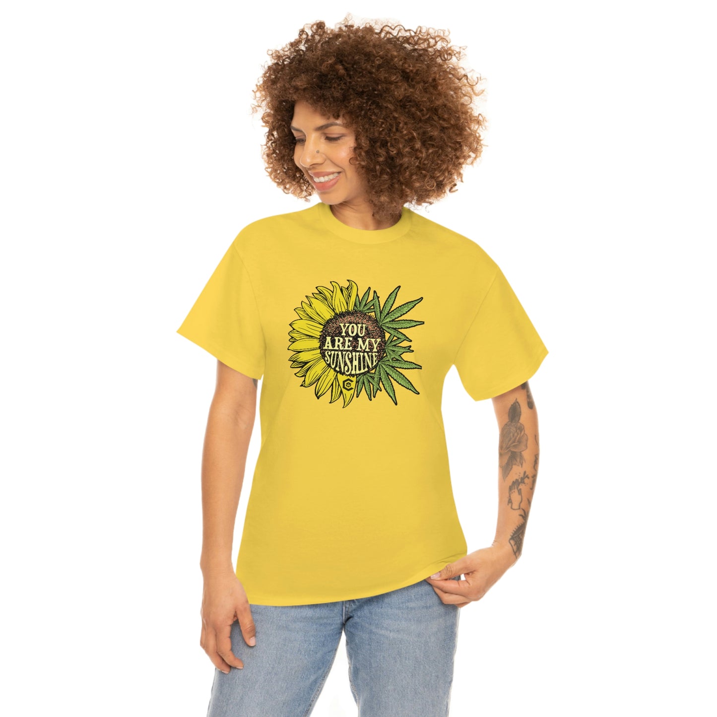 a woman wearing a "You Are My Sunshine Weed" t-shirt with a sunflower on it.