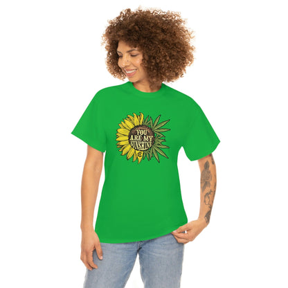 a woman wearing a You Are My Sunshine Weed T-Shirt with a sunflower on it.