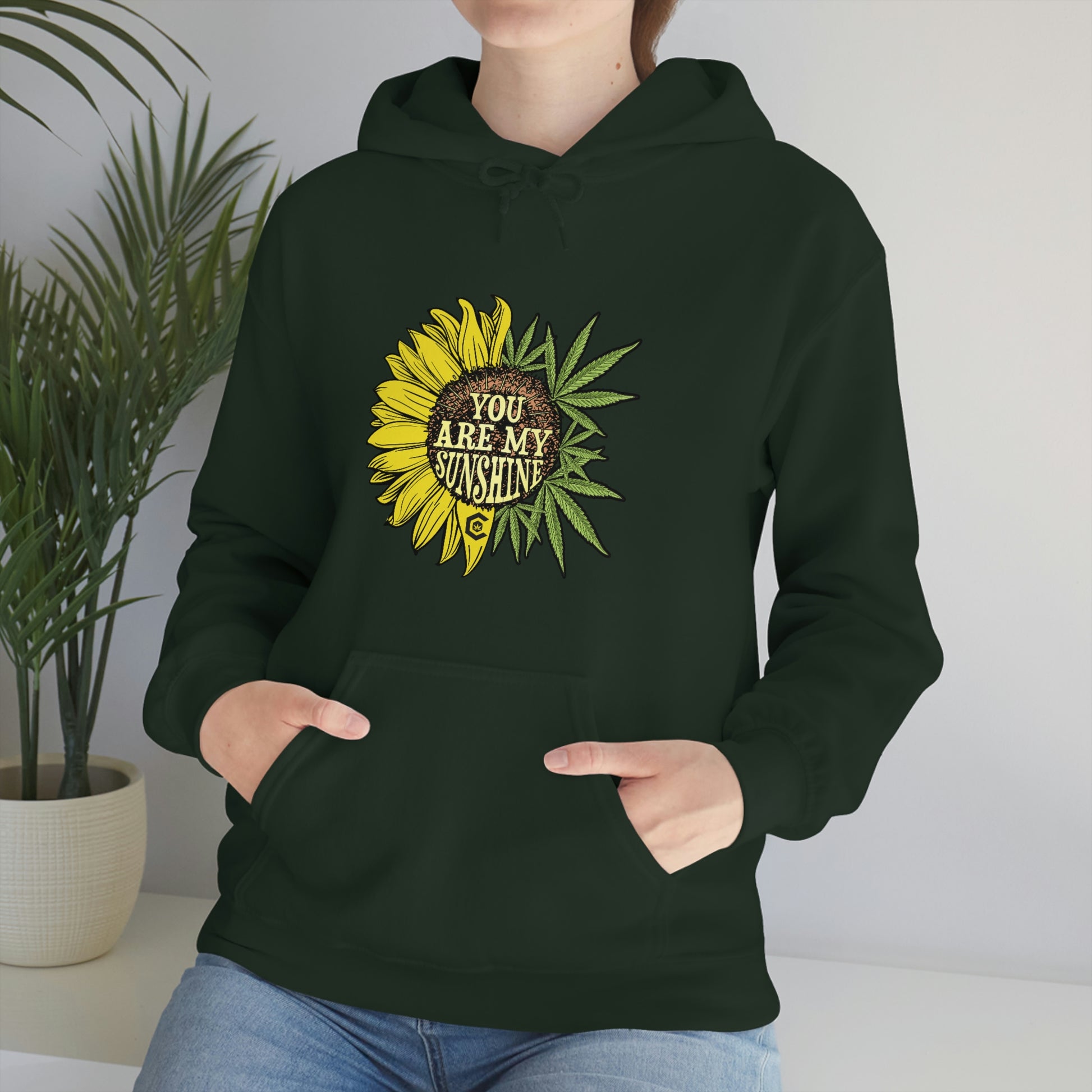 a person wearing a You Are My Sunshine Cannabis Sweatshirt.
