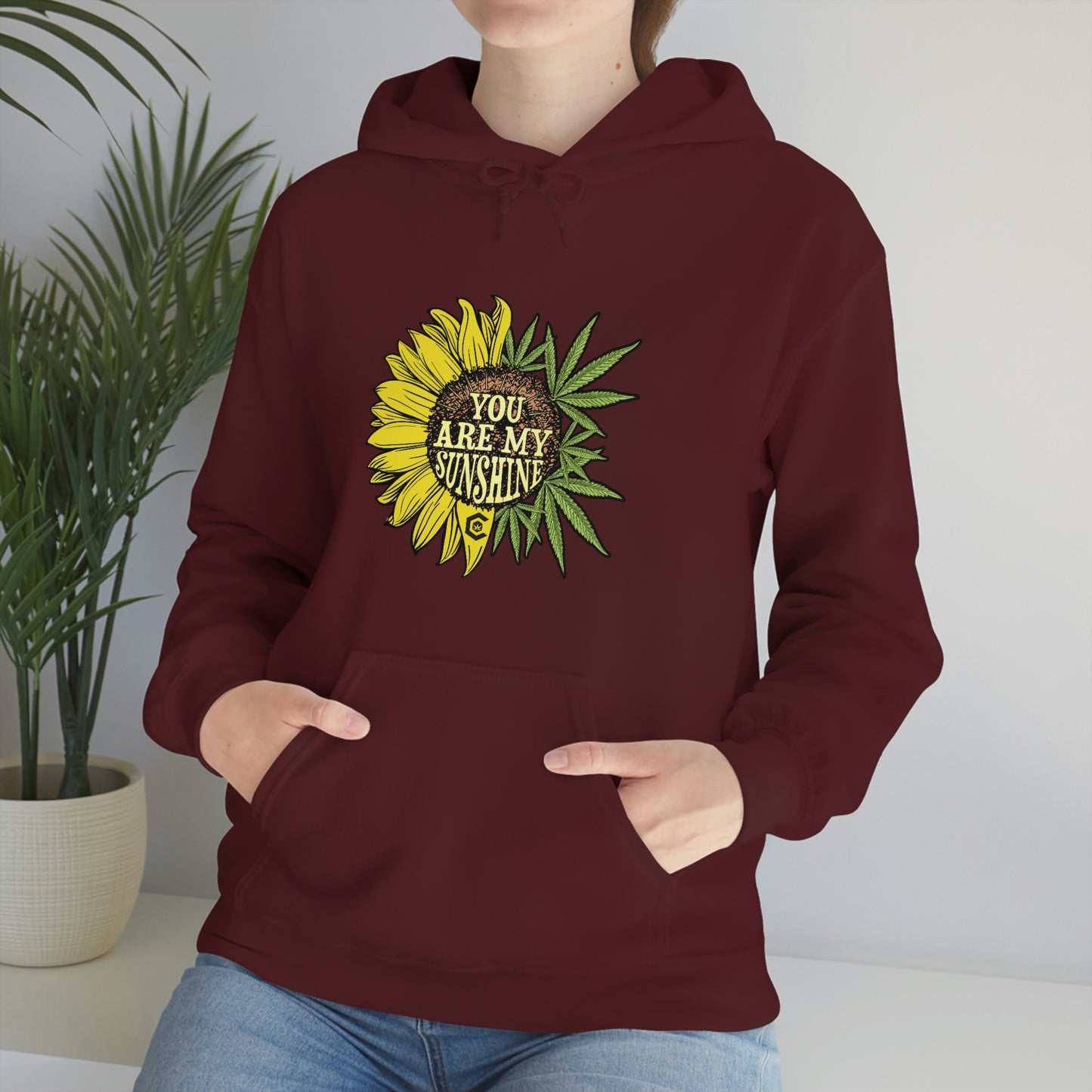 a person wearing a You Are My Sunshine Cannabis Sweatshirt.