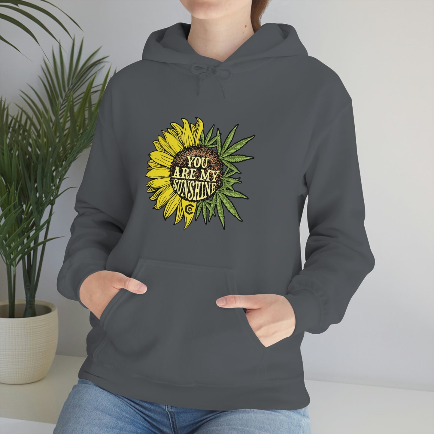 a woman wearing a You Are My Sunshine Cannabis Sweatshirt
