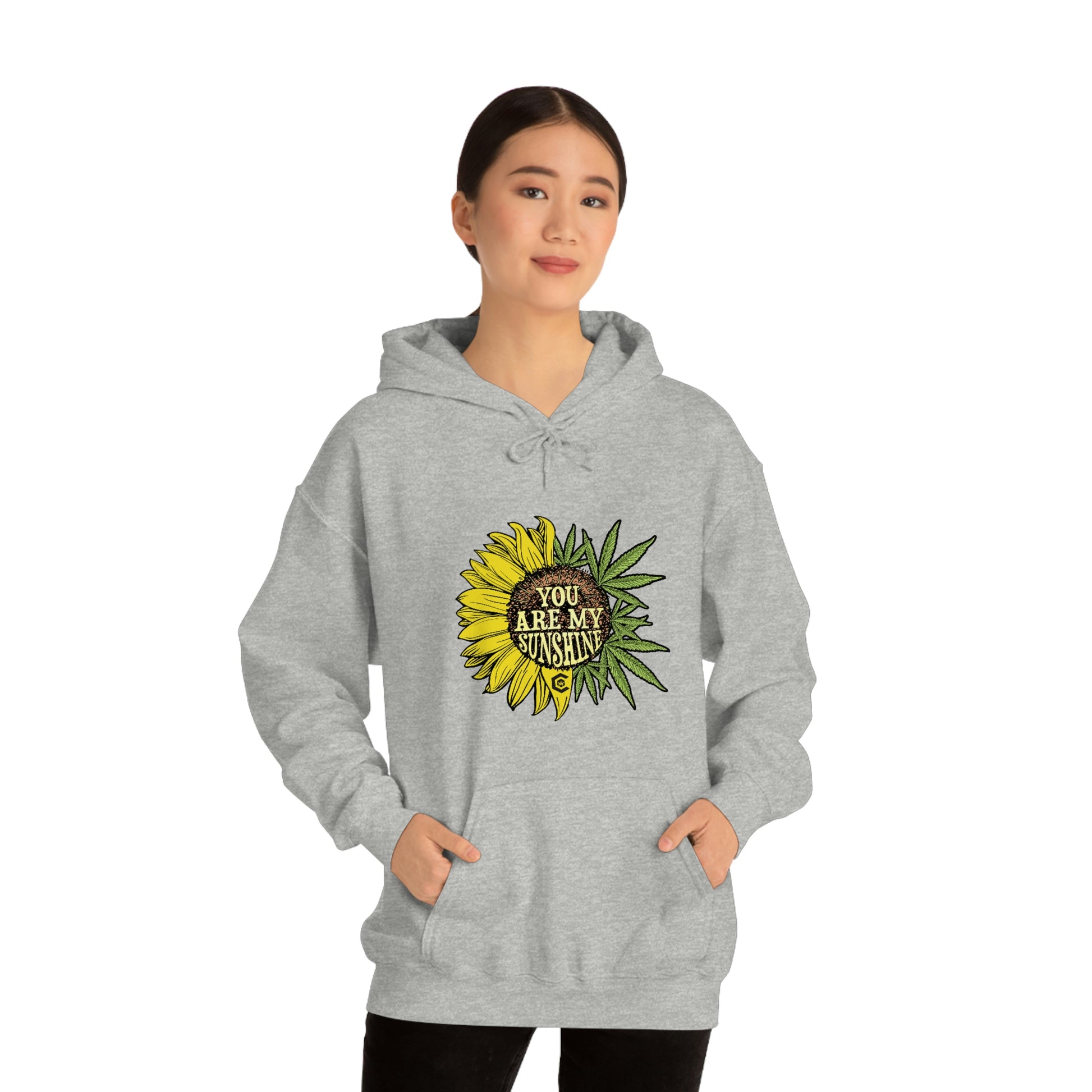 a woman wearing a You Are My Sunshine Cannabis Sweatshirt.